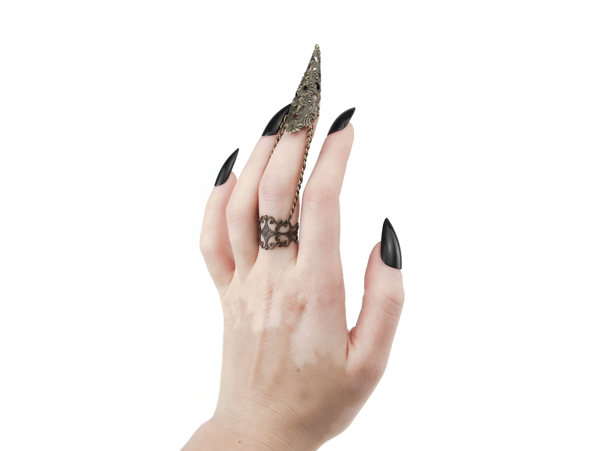 A bold and striking Myril Jewels bronze armor ring with claw, designed with a dark-avantgarde aesthetic, adorns a hand with sleek black nails, perfect for those with a love for gothic, Witchcore, and Neo Gothic styles. This finely crafted piece is a testament to gothic-chic sophistication, making it a versatile choice for Halloween, everyday wear, or as a statement accessory for the alternative fashion lover.