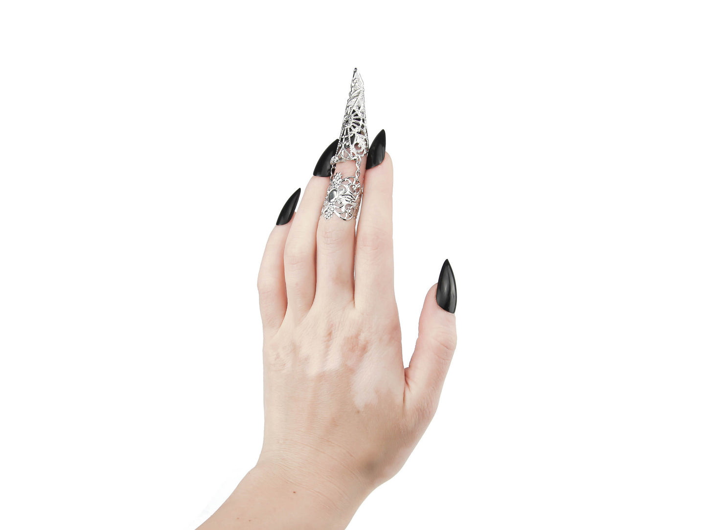 A hand adorned with Myril Jewels' distinctive claw ring captures the essence of neo-gothic allure. This dark-avantgarde accessory, worn on the middle finger, features an elaborate lace-like pattern that extends over the finger to mimic a dramatic claw, perfect for gothic and alternative style aficionados. The ring's bold design makes a statement, ideal for minimal goth daily wear or as an eye-catching piece for Halloween, rave parties, and festival jewels