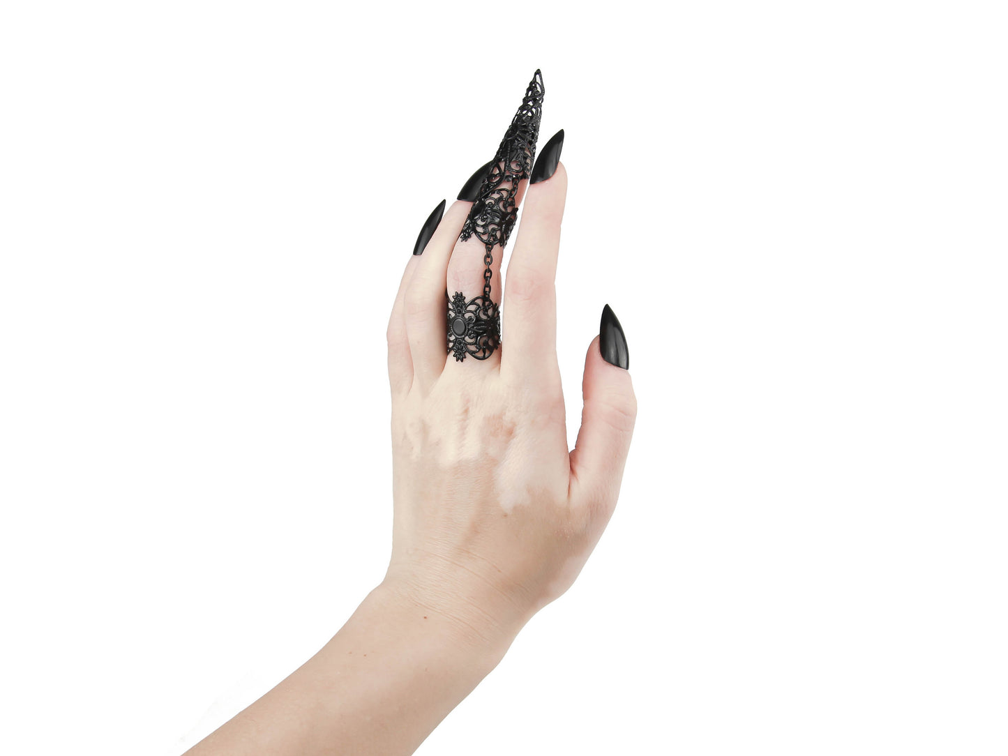 Experience the allure of the dark and avant-garde with Myril Jewels' handcrafted armor-like ring, a statement piece for the modern goth. This Neo Gothic claw ring, showcased on a hand with matching black nails, exemplifies the bold and unique aesthetics of gothic-chic. Perfect for those who embrace a witchcore or whimsigoth lifestyle, it adds a touch of edgy sophistication to any outfit. This ring is a versatile accessory that seamlessly transitions from Halloween celebrations to everyday minimal goth wear