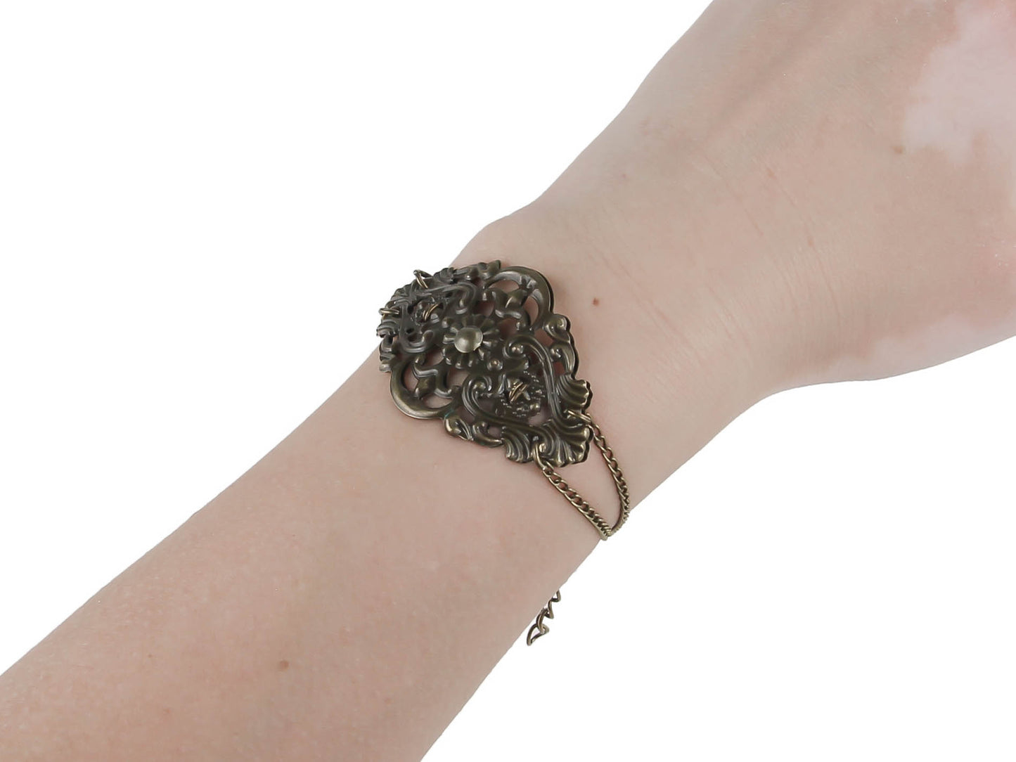 This Myril Jewels filigree bracelet exudes a darkly romantic allure, perfect for the avant-garde gothic enthusiast. Intricately designed, the bracelet blends timeless filigree art with modern punk accents, ideal for Halloween, Neo Gothic events, and Gothic-chic fashion. It's a versatile piece that also resonates with the Whimsigoth and Witchcore communities, offering a touch of everyday elegance to the minimal goth wardrobe