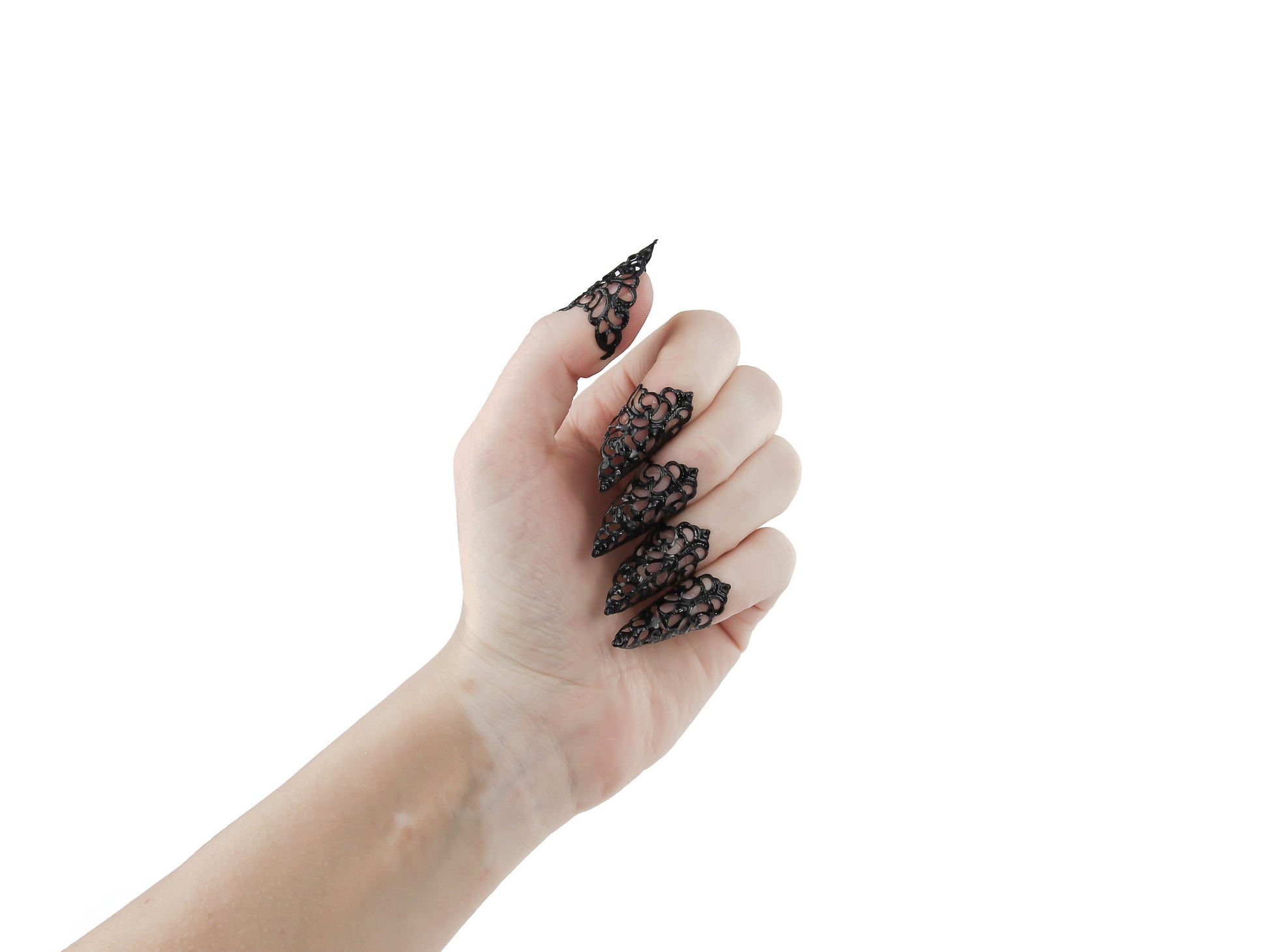 An image displays a hand adorned with Myril Jewels' gothic black nail jewels, exuding a neo-goth aesthetic with their claw-like design. These intricate black claws are perfect for Halloween, embodying punk and whimsigoth styles, and serve as bold jewelry for everyday wear or special events like raves and festivals. They are an ideal gift for the goth girlfriend who cherishes dark, alternative fashion.
