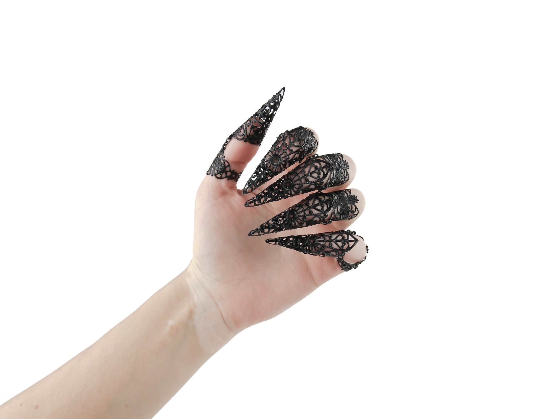 Step into the world of Myril Jewels with this captivating full hand set of midi rings, masterfully designed with claw-like extensions for a bold neo-goth statement. These black rings exude a dark-avantgarde allure, perfect for those who embrace gothic-chic and whimsigoth styles. The intricate detail of each piece makes it an essential accessory for Halloween, while also being versatile enough for everyday wear.