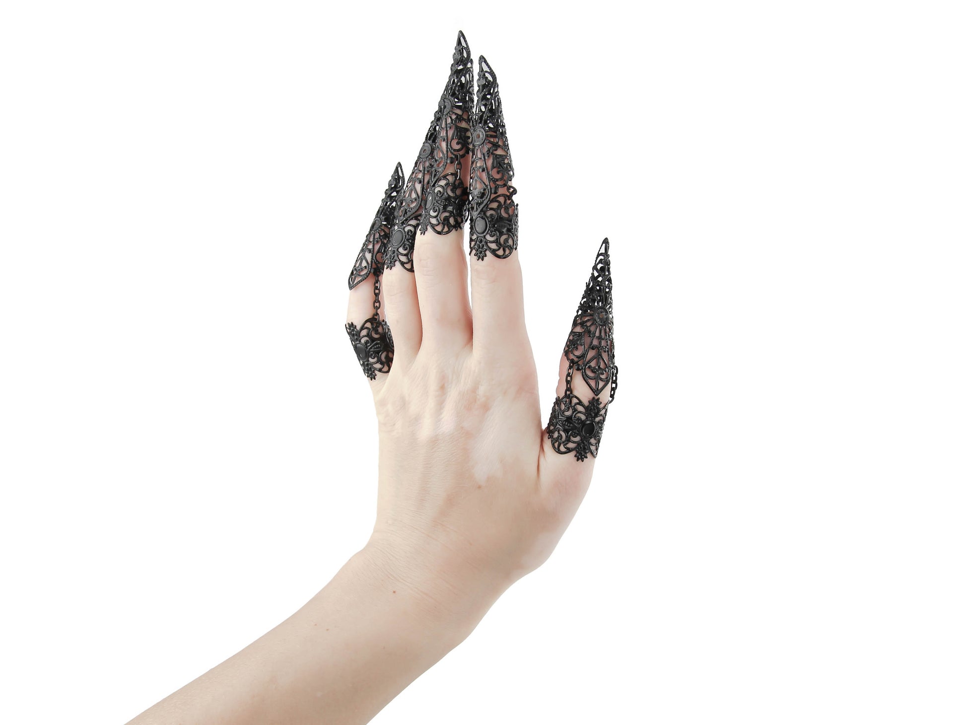 Step into the world of Myril Jewels with this captivating full hand set of midi rings, masterfully designed with claw-like extensions for a bold neo-goth statement. These black rings exude a dark-avantgarde allure, perfect for those who embrace gothic-chic and whimsigoth styles. The intricate detail of each piece makes it an essential accessory for Halloween, while also being versatile enough for everyday wear.