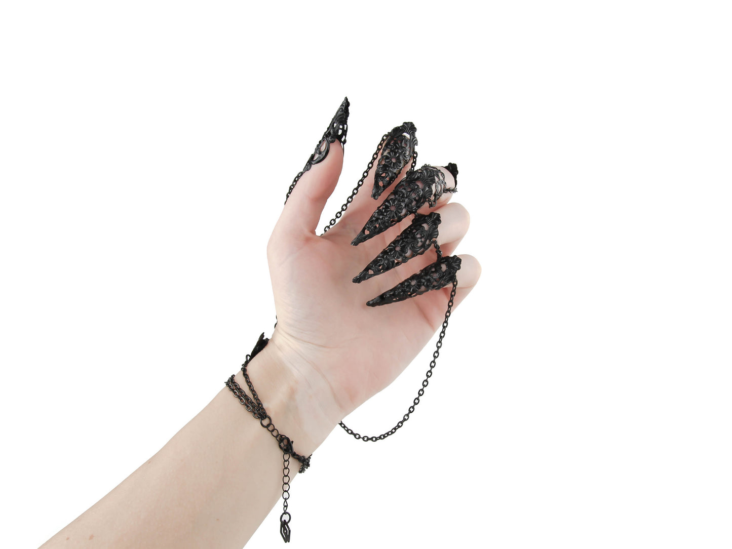Elevate your style with this Myril Jewels black hand chain bracelet, a vision of neo-goth craftsmanship. Each black chain drapes elegantly from a wrist cuff to filigree claw rings, perfect for gothic-chic fashion lovers and a standout choice for bold everyday wear.