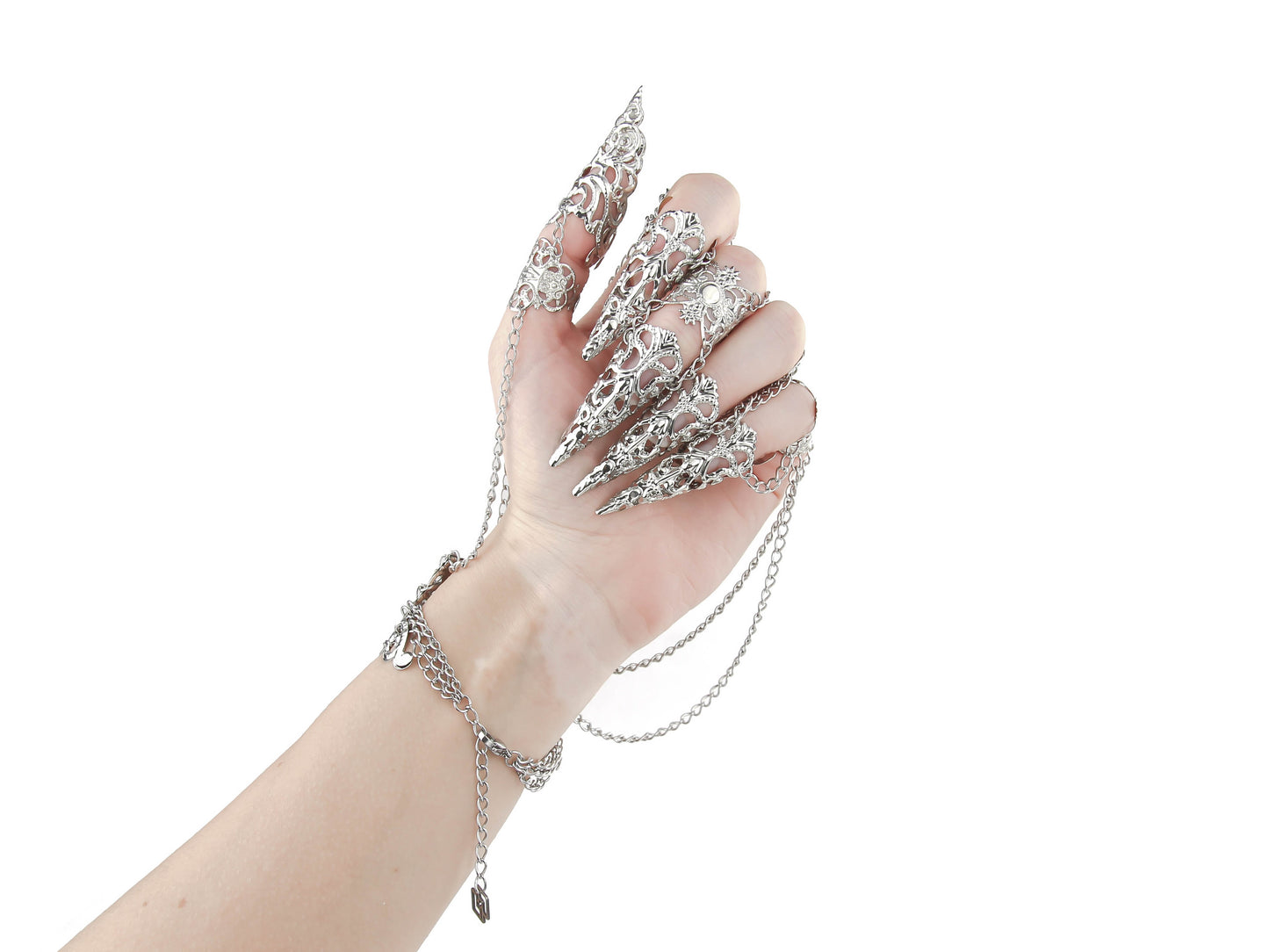 A hand dons a Myril Jewels metal glove with elaborate silver finger claw rings, perfect for a dark avant-garde aesthetic. This statement piece is ideal for those who love gothic-chic jewelry, making it a unique accessory for Halloween, witchcore fashion, or as a bold addition to festival and rave outfits.