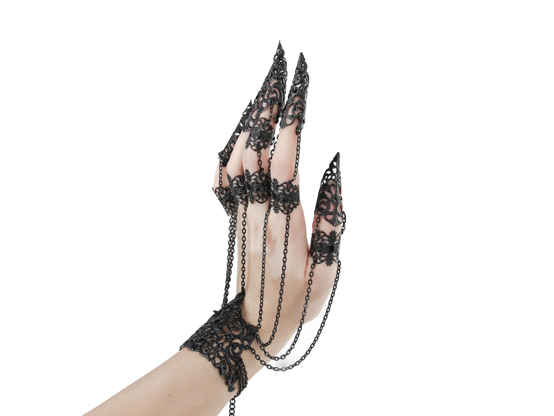 An ornate black metal glove with finger claw rings, from Myril Jewels, epitomizes dark avant-garde elegance. Perfect for gothic enthusiasts, this piece is ideal for Halloween, festival wear, or as a distinctive gift, combining boldness with the intricate beauty of neo-gothic jewelry.