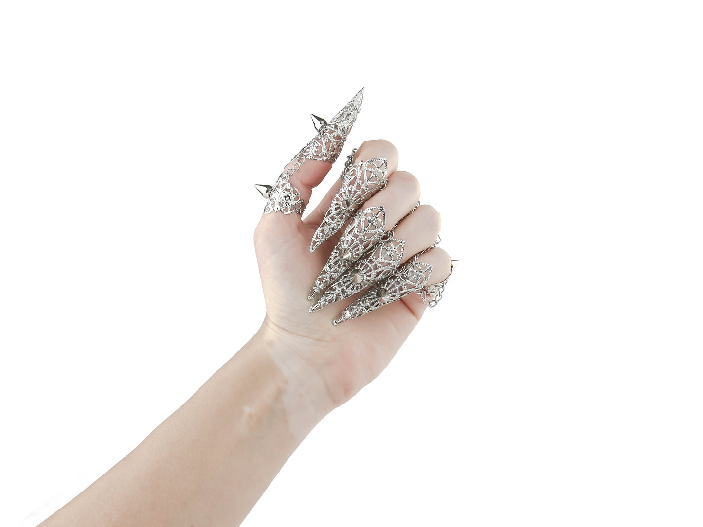 A hand is adorned with a striking set of Myril Jewels silver claw rings, featuring delicate filigree and bold studs. These pieces embody the essence of neo-gothic luxury, perfect for anyone looking to add a touch of dark, avant-garde elegance to their Halloween or everyday gothic-chic style.