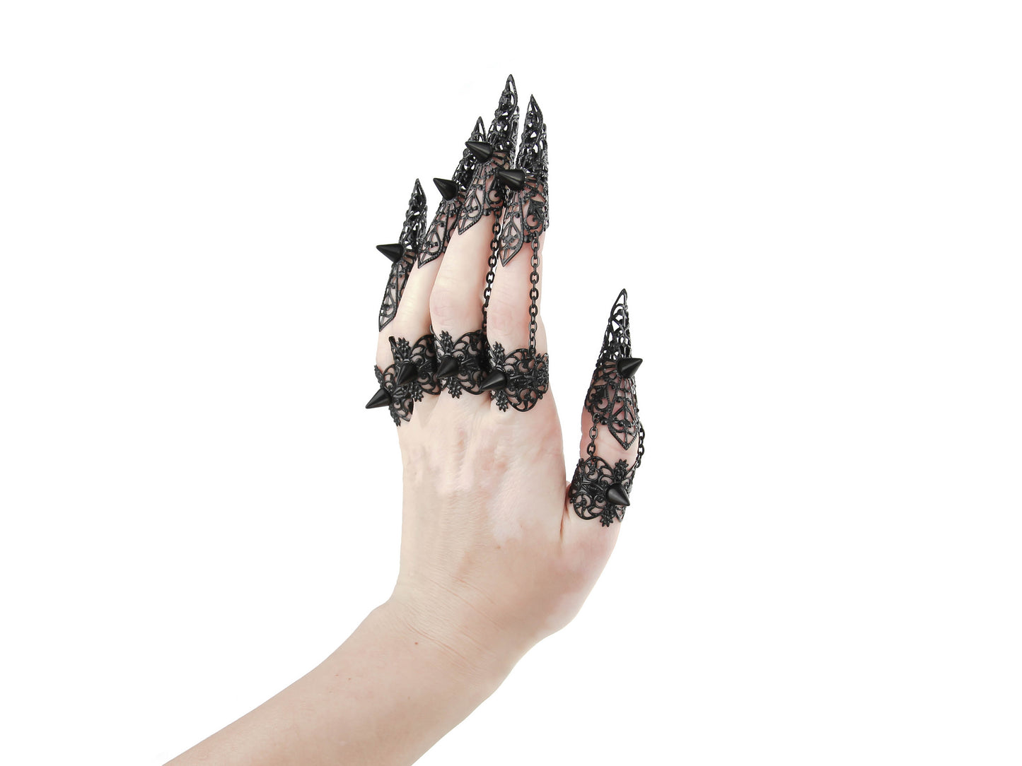 A set of black claw rings with studs adorns a hand, exemplifying the dark-avantgarde style of Myril Jewels. These bold, neo-gothic pieces are a fit for Halloween, adding a punk edge to gothic-chic looks, perfect for the fashion-forward goth girlfriend or as a daring festival jewel.
