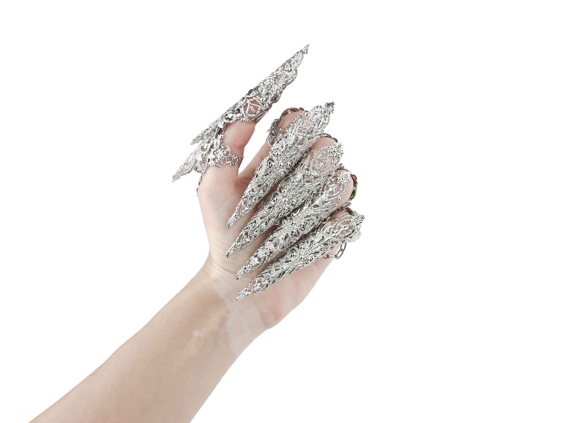 An alluring hand showcasing Myril Jewels' dragon-like claw rings set, with elaborate silver detailing perfect for gothic and alternative fashion enthusiasts. This neo-goth masterpiece is ideal for Halloween, a rave, or as an eye-catching everyday accessory for those who dare to stand out.