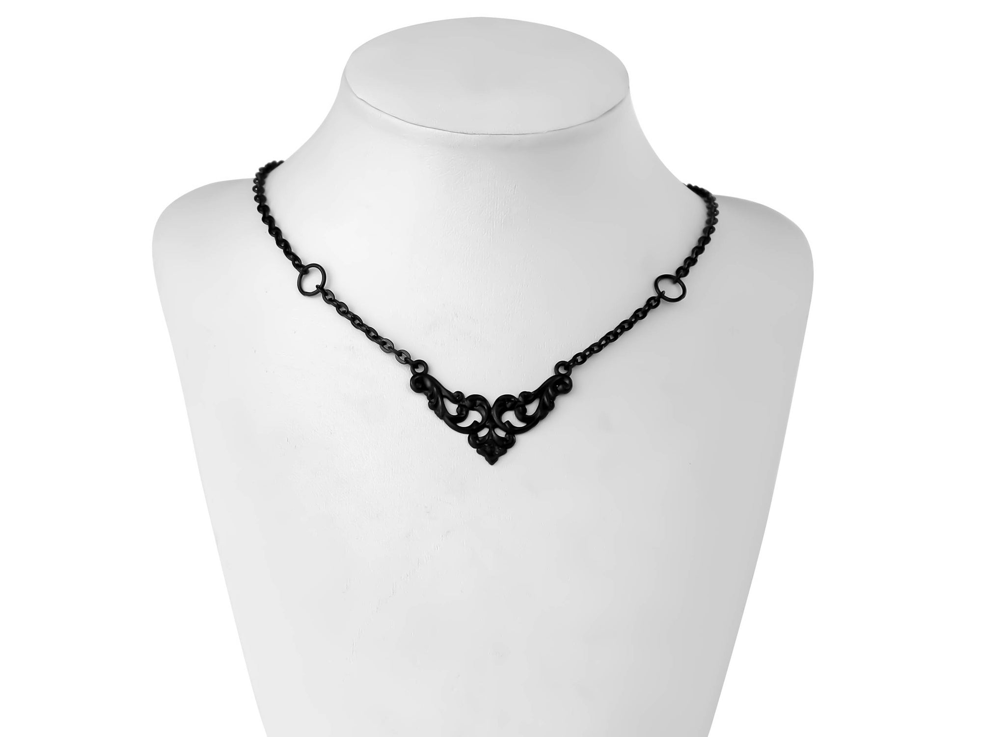 A Myril Jewels gothic necklace displayed on a mannequin, featuring delicate black filigree work that forms an elegant centerpiece. The black necklace combines timeless gothic motifs with modern elegance, making it a versatile piece for Halloween events, punk fashion, and everyday wear. It reflects the dark-avantgarde style that Myril Jewels is known for, appealing to those who favor gothic-chic, whimsigoth, and witchcore aesthetics