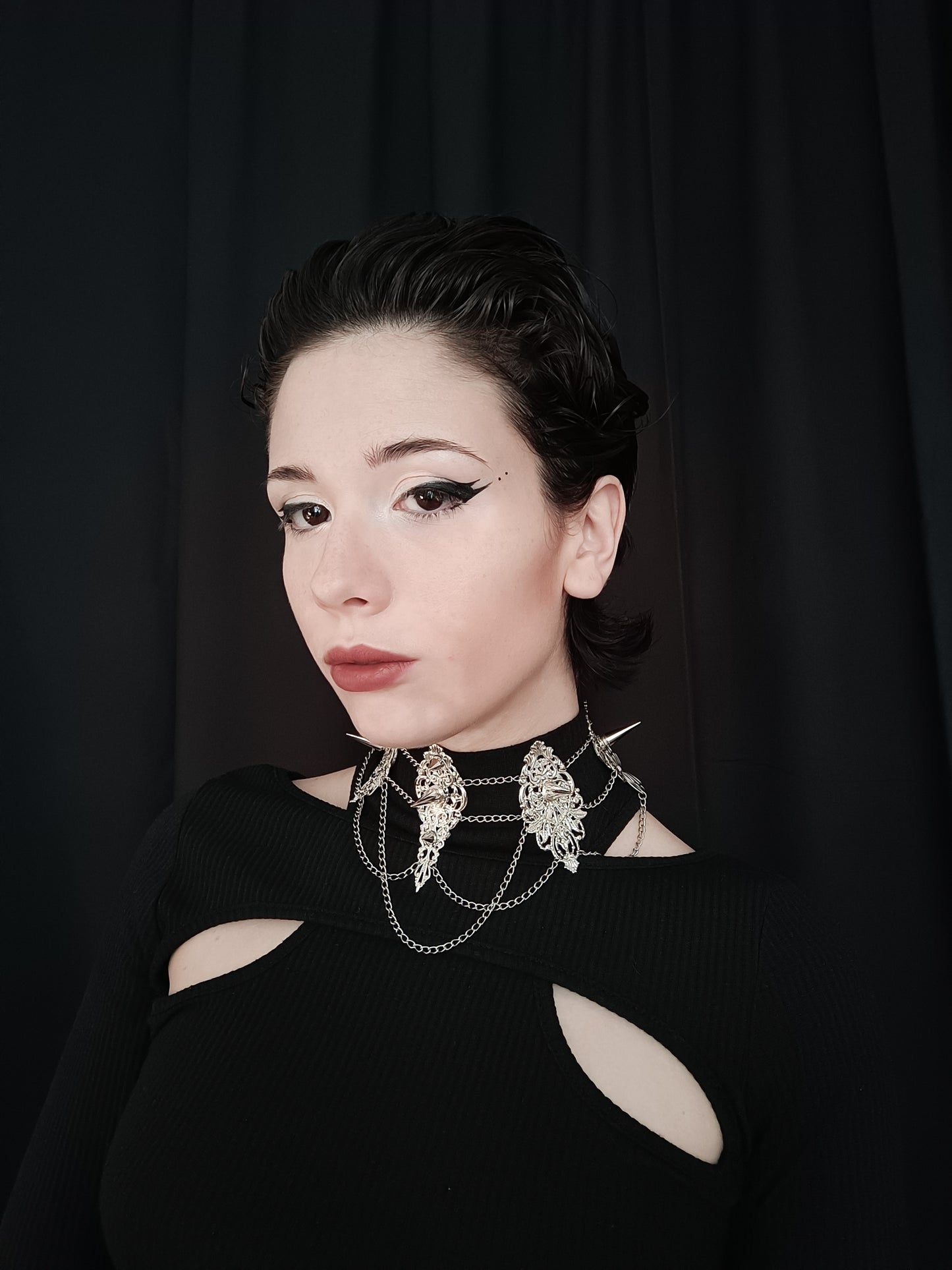 Striking studded choker by Myril Jewels, featuring elaborate filigree work and bold spikes, embodying the essence of neo-gothic jewelry. This piece is perfect for witchcore enthusiasts or as a standout accessory for Halloween and gothic-chic events.