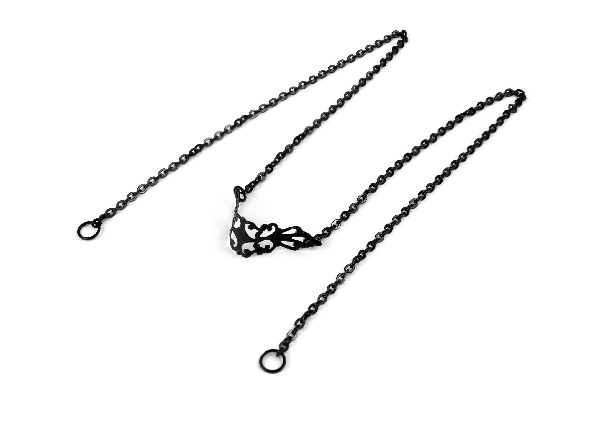 Elegant Myril Jewels black nose chain with delicate filigree detailing, laid against a white background, representing neo-gothic charm for an edgy, alternative look