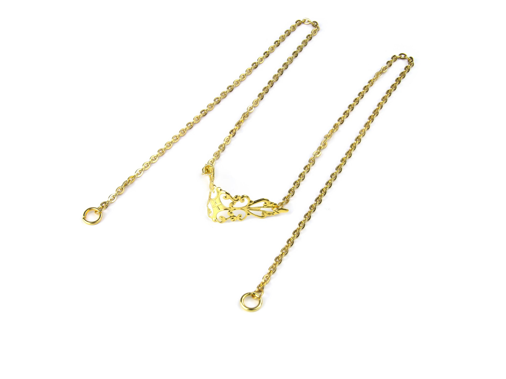 This image features a Myril Jewels gold nose chain with a delicate silver filigree design, laid out on a white background, capturing the essence of neo-gothic jewelry for a statement look