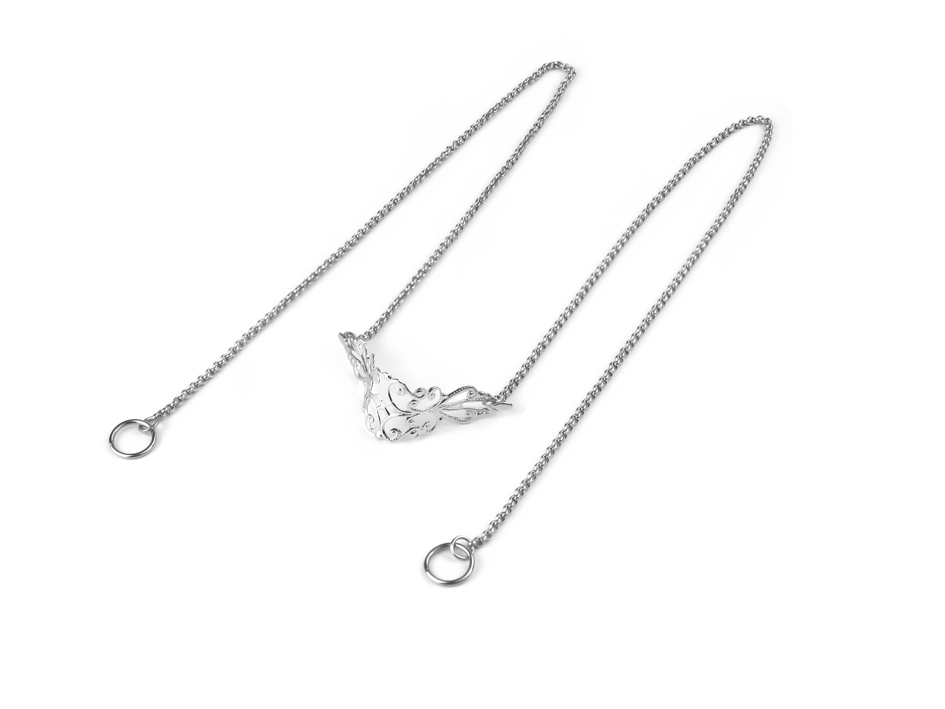 A sleek Myril Jewels nose chain with delicate filigree work, set against a crisp white background, epitomizing neo-gothic style for a dramatic, alternative look