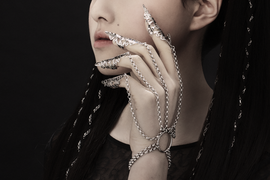 A captivating hand chain bracelet with nail claws from Myril Jewels, blending gothic allure and avant-garde design. This bold jewelry piece is perfect for those embracing a dark, whimsigoth aesthetic, ideal for adding a neo-gothic touch to any Halloween or festival outfit, or as a unique goth girlfriend gift