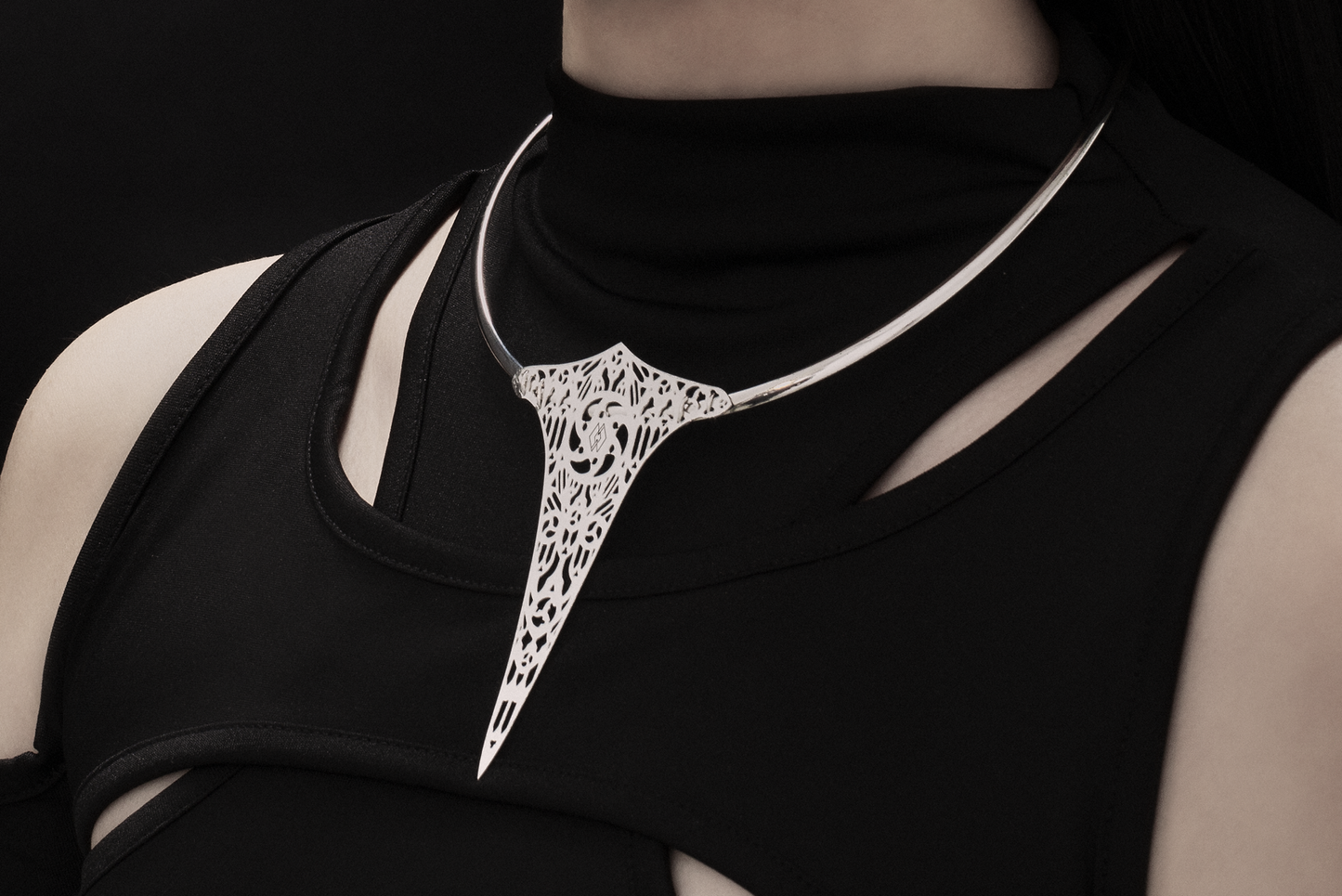 A model wears a Myril Jewels rigid V-shaped necklace, featuring a gothic church motif, exuding a dark avant-garde elegance suitable for gothic and alternative style enthusiasts. Ideal for Halloween, rave events, or as a distinctive goth girlfriend gift, it reflects minimal goth sophistication.