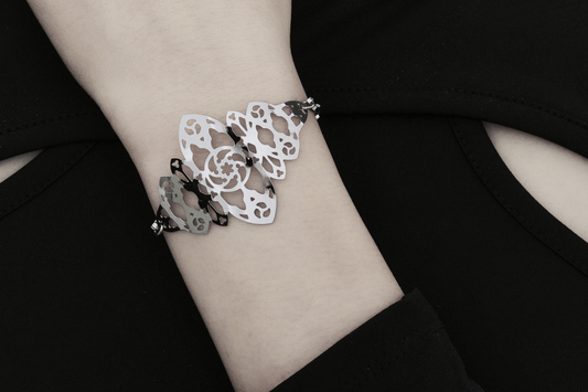 A model poses with a Myril Jewels bracelet inspired by gothic architecture. The intricate design embodies the brand’s dark-avantgarde signature, suitable for gothic, Witchcore, and whimsigoth enthusiasts, and is a perfect accessory for Halloween or as a distinctive gift for someone special.