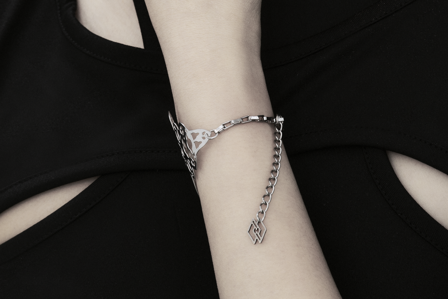 A model is featured wearing a Myril Jewels bracelet with a gothic architecture design. The intricate cut-out pattern creates a stunning visual effect against the simplicity of the black attire, making it a perfect accessory for those who favor gothic-chic or neo-goth styles, whether for daily wear or special events.