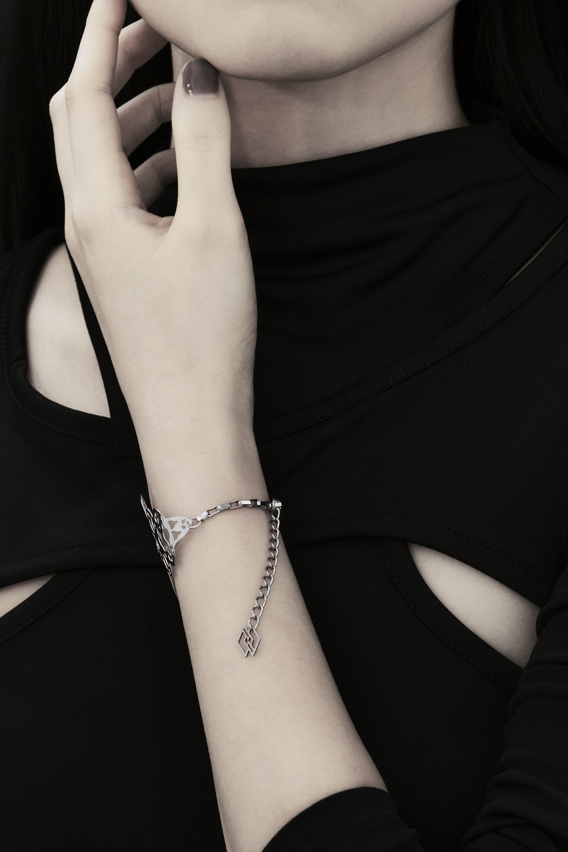 A model is featured wearing a Myril Jewels bracelet with a gothic architecture design. The intricate cut-out pattern creates a stunning visual effect against the simplicity of the black attire, making it a perfect accessory for those who favor gothic-chic or neo-goth styles, whether for daily wear or special events.