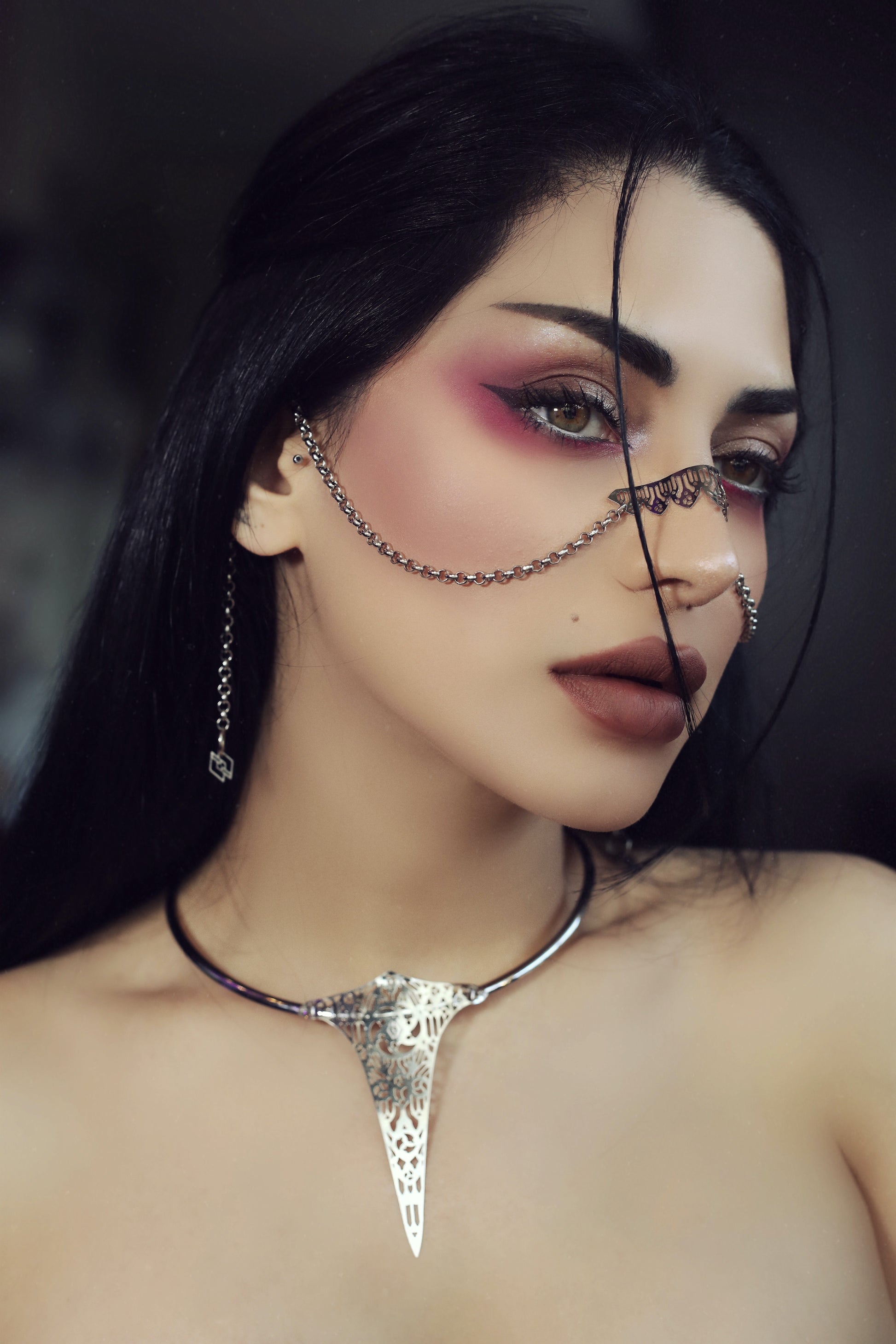 A model presents a Myril Jewels nose chain, accentuating a neo-goth aesthetic. This bold jewelry piece, perfect for goth girlfriend gifts, adds a witchcore touch to any outfit, ideal for Halloween, festival wear, or daily expression of gothic-chic style.