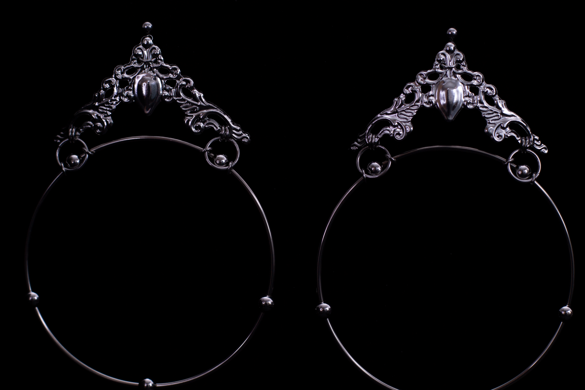 Showcasing Myril Jewels’ bold gothic hoop earrings, these pieces flaunt wide loops with ornate, gothic-inspired filigree and a central teardrop gemstone, radiating dark elegance. Ideal for the gothic-chic, these earrings are a statement accessory for Halloween, festivals, or as a distinctive gift for the goth-loving friend
