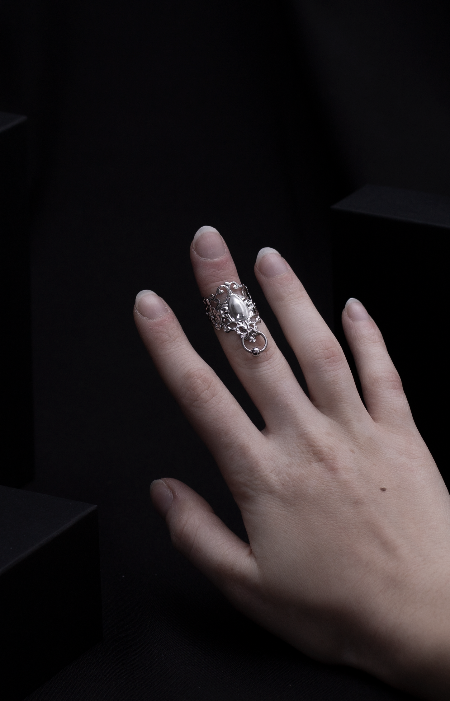 An alluring Myril Jewels midi ring with neo-gothic charm, featuring delicate filigree and a bold, tear-shaped centerpiece. Crafted for the dark fashion connoisseur, it's a quintessential accessory for a whimsigoth or witchcore ensemble, perfect for both daily gothic-chic statements and as an audacious festival jewel.