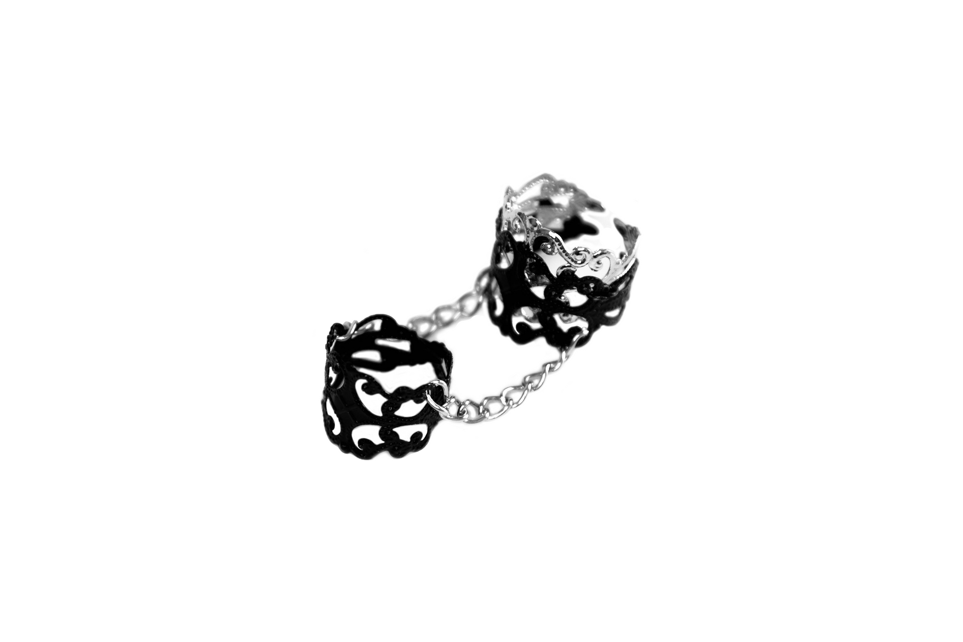 A Myril Jewels double ring, connecting two intricate bands with a delicate chain. With its Neo Gothic flair, this piece is a perfect touch for Halloween ensembles, witchcore aesthetics, or as a distinctive goth girlfriend gift. It encapsulates the essence of minimal goth, ideal for both everyday wear and festival occasions.