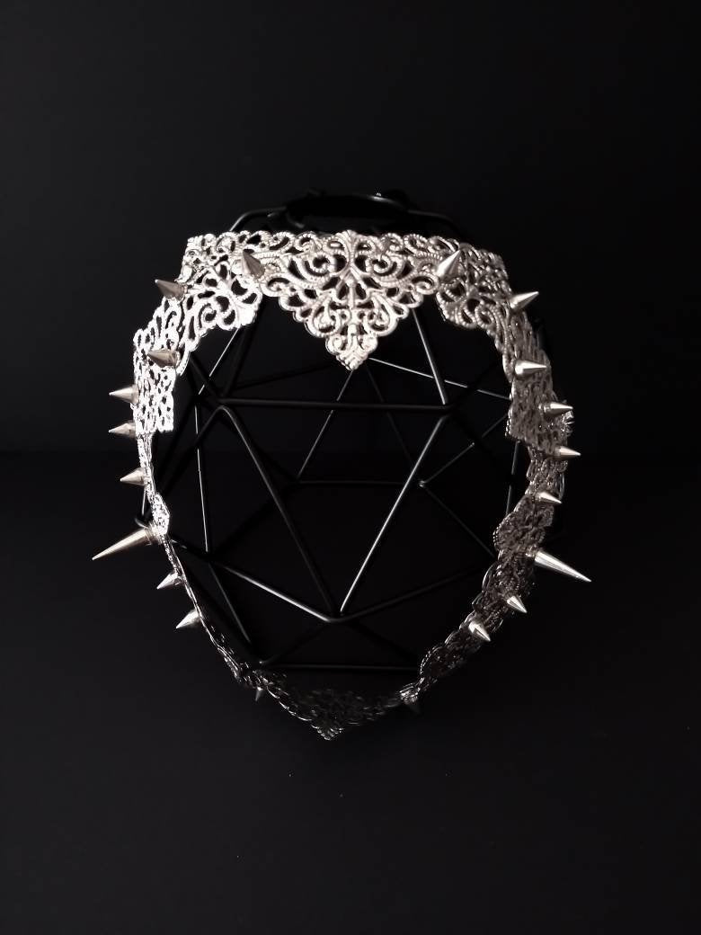 "A striking Myril Jewels punk filigree face frame mask, adorned with edgy studs, embodying the dark-avantgarde aesthetic for gothic and alternative fashion lovers
