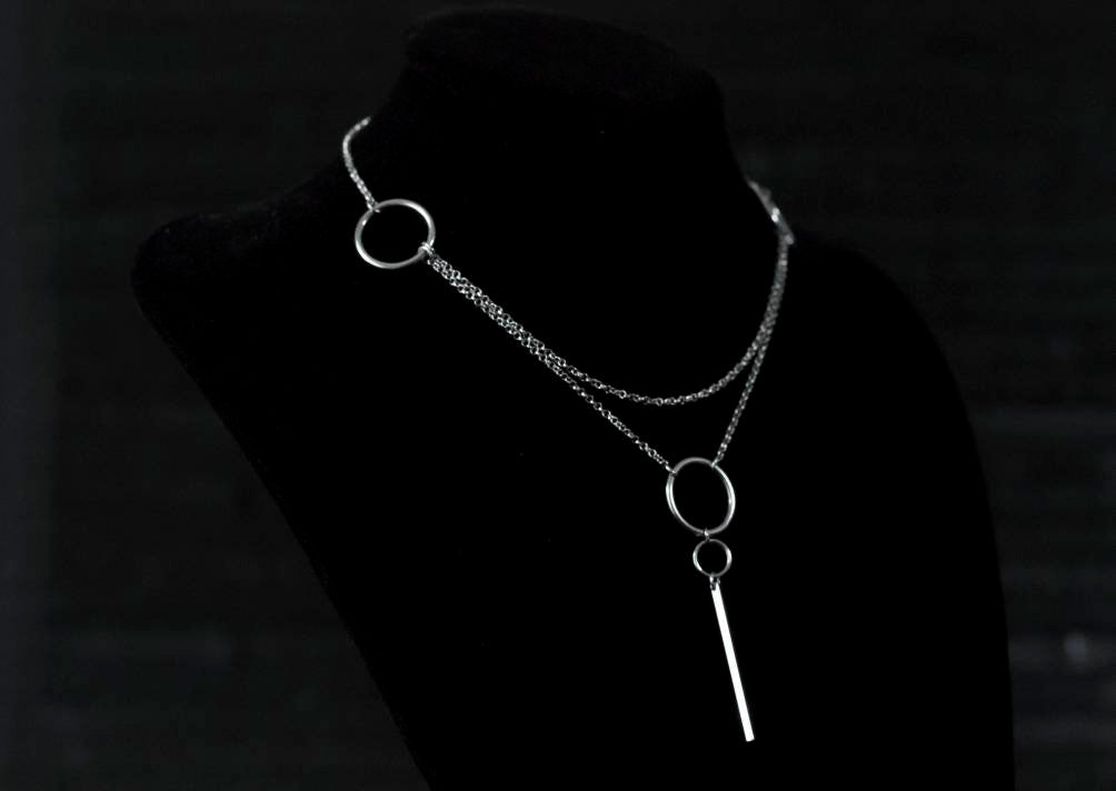 A Myril Jewels minimal chain necklace displayed on a black backdrop, featuring simple hoops for a refined neo-goth aesthetic, suitable for gothic-chic fashion connoisseurs.