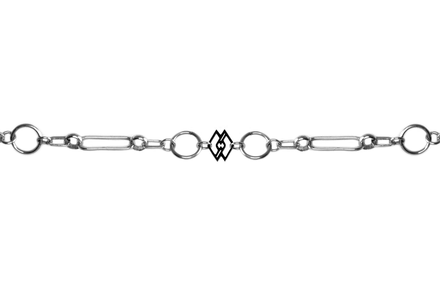 This is a sleek Myril Jewels chain-style bracelet, embodying a dark avant-garde aesthetic perfect for gothic and alternative fashion enthusiasts. The design showcases an intricate series of silver links, alternating between classic circular shapes and unique geometrical forms, culminating in a distinct rectangular charm that adds a modern twist. Ideal for everyday wear, this piece seamlessly fits into a minimal goth wardrobe while making a subtle statement. 