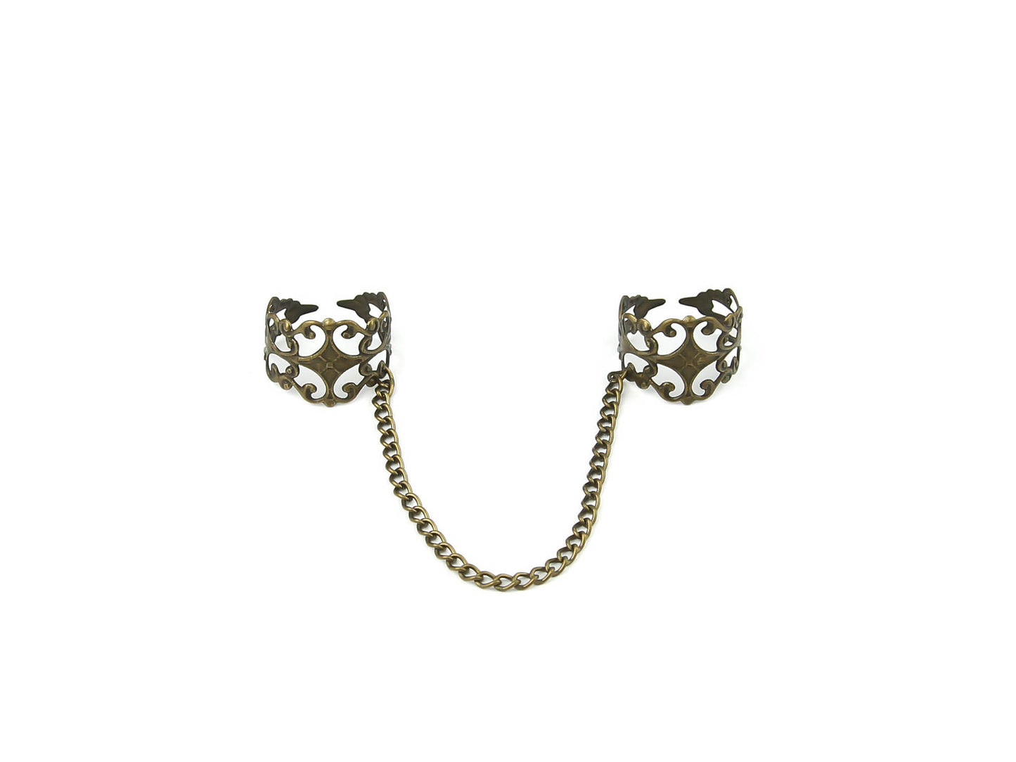 Intricate Myril Jewels double ring connected by a bronze chain, showcasing a blend of dark-avantgarde and neo-gothic design. This handcrafted Italian piece captures the essence of gothic-chic with its ornate, baroque-style detailing, perfect for gothic and alternative style aficionados. Ideal for adding a touch of whimsigoth elegance to Halloween or everyday witchcore ensembles.