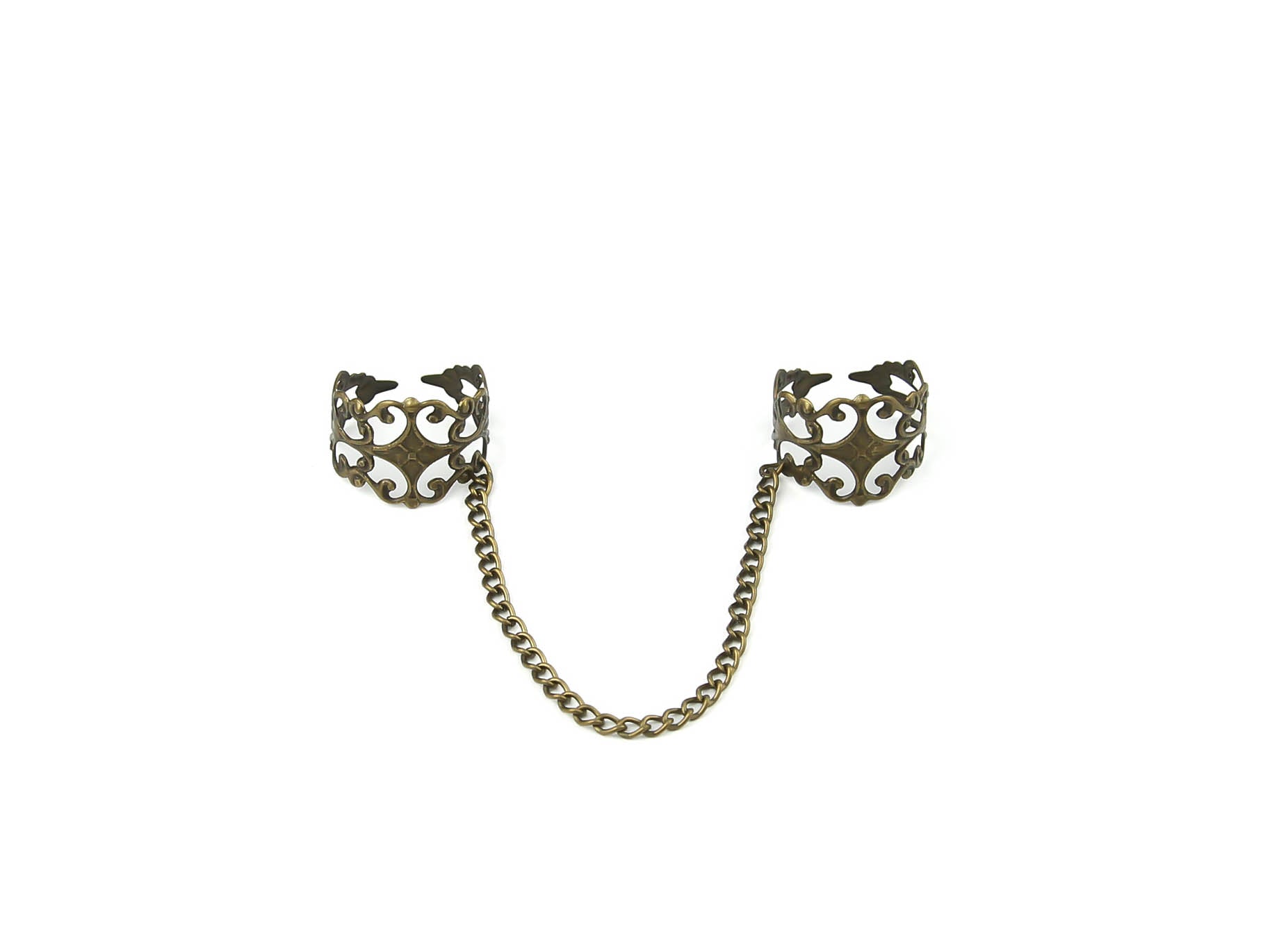 Intricate Myril Jewels double ring connected by a bronze chain, showcasing a blend of dark-avantgarde and neo-gothic design. This handcrafted Italian piece captures the essence of gothic-chic with its ornate, baroque-style detailing, perfect for gothic and alternative style aficionados. Ideal for adding a touch of whimsigoth elegance to Halloween or everyday witchcore ensembles.
