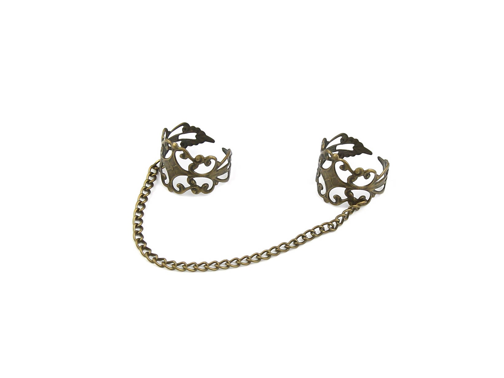 Intricate Myril Jewels double ring connected by a bronze chain, showcasing a blend of dark-avantgarde and neo-gothic design. This handcrafted Italian piece captures the essence of gothic-chic with its ornate, baroque-style detailing, perfect for gothic and alternative style aficionados. Ideal for adding a touch of whimsigoth elegance to Halloween or everyday witchcore ensembles.