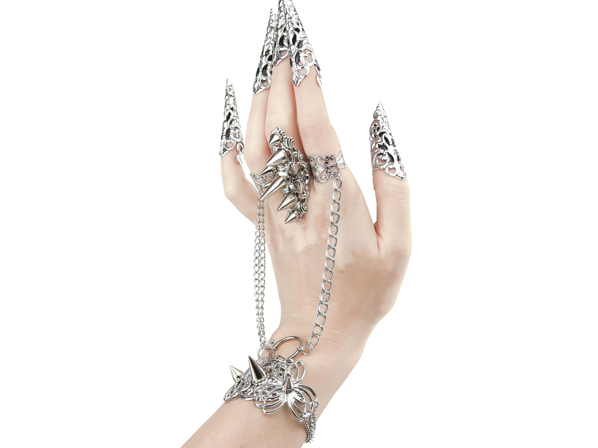 Capture the essence of punk rebellion with Myril Jewels' edgy studded ring with matching hand chain bracelet ring and nail claw rings . These bold statement pieces, with its sharp studs and metallic finish, are a must-have for lovers of dark-avantgarde and gothic accessories. Ideal for Halloween, it also complements everyday minimal goth looks, Witchcore styles, and Gothic-chic ensembles, offering a versatile addition to any Neo Gothic jewel collection