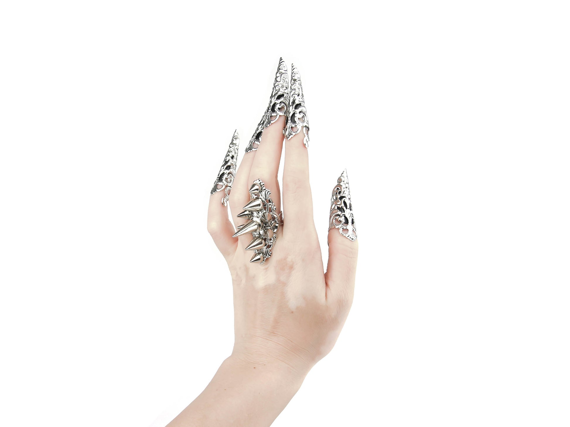 Capture the essence of punk rebellion with Myril Jewels' edgy studded ring and matching nail claw rings. These bold statement pieces, with its sharp studs and metallic finish, are a must-have for lovers of dark-avantgarde and gothic accessories. Ideal for Halloween, it also complements everyday minimal goth looks, Witchcore styles, and Gothic-chic ensembles, offering a versatile addition to any Neo Gothic jewel collection