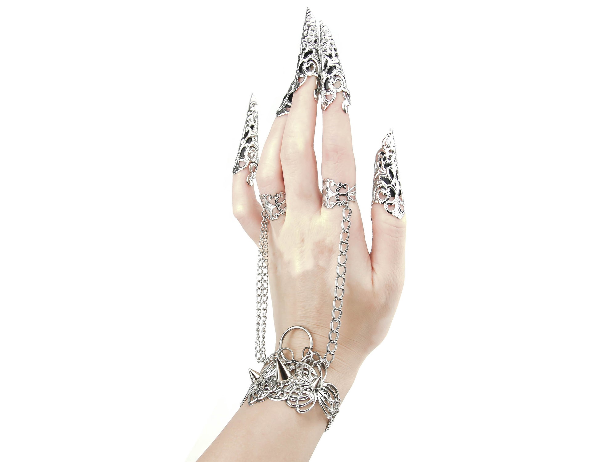This striking Myril Jewels punk jewelry set, featuring a hand chain bracelet with ring, and nail claw rings, exemplifies the cutting-edge style of dark avant-garde fashion. Crafted with precision, the set's silver studs and intricate filigree cater to enthusiasts of Neo Gothic and Gothic-chic trends, making it an ideal choice for Halloween, everyday wear, and special occasions like rave parties and festivals. Each piece is designed to make a bold statement