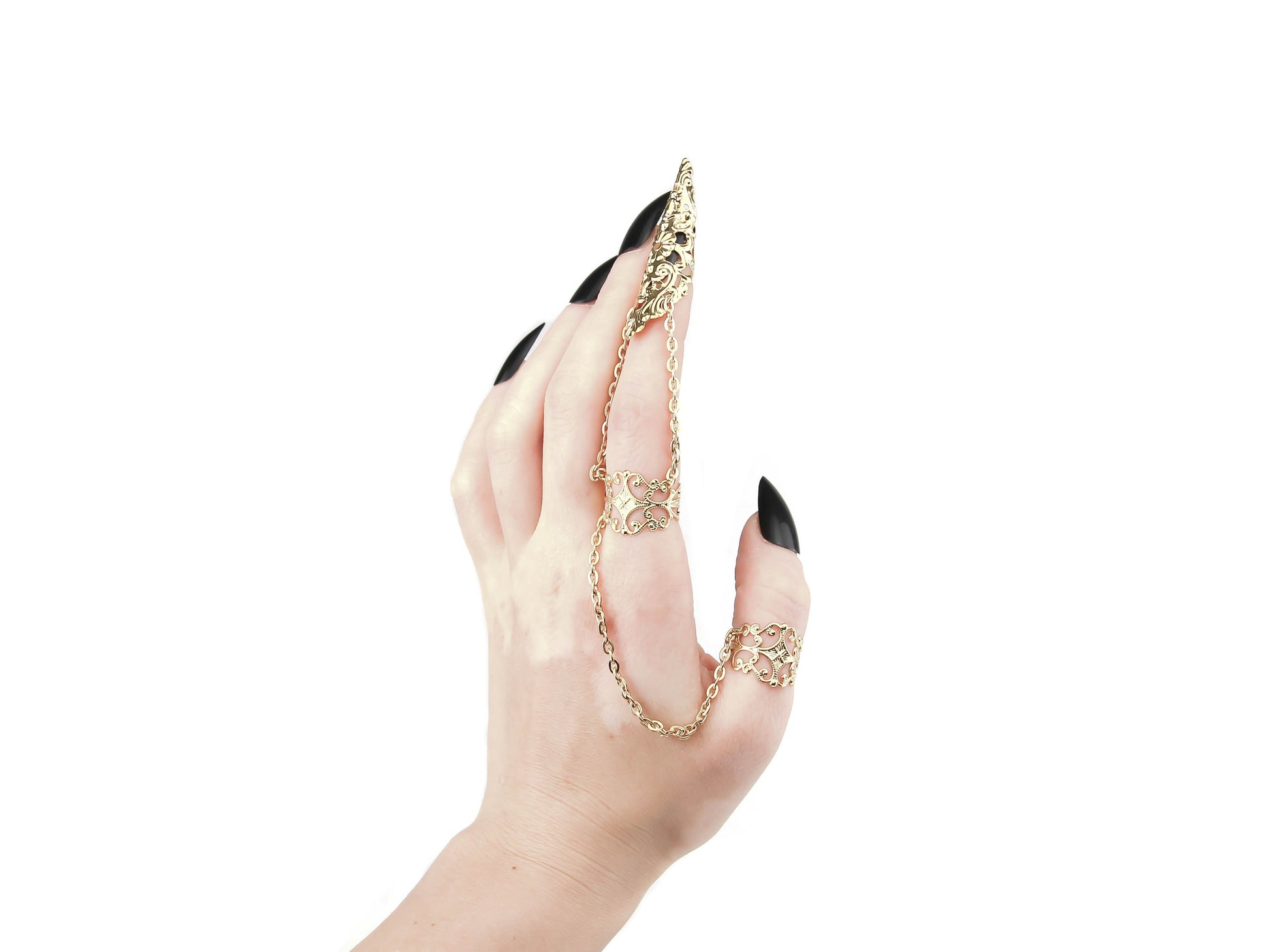 A hand models a Myril Jewels double ring, extending into a claw over the middle finger, crafted with intricate golddetailing. This piece is a bold statement of neo-gothic design, ideal for those who favor dark, avant-garde accessories. It's perfect for complementing a Halloween outfit, enhancing a punk wardrobe, or adding a touch of whimsigoth to everyday wear.