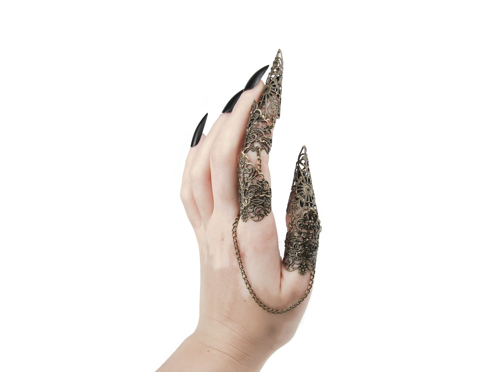 A hand is adorned with an intricate Myril Jewels gothic full finger double ring, extending into elegant claws over the fingertips. The claw ring's elaborate bronze filigree design embodies the essence of neo-gothic jewelry, perfect for those who seek a dark, avant-garde accessory. This piece is a statement in the world of gothic-chic and whimsigoth style, ideal for Halloween, everyday wear, or as a distinctive addition to rave party and festival outfits