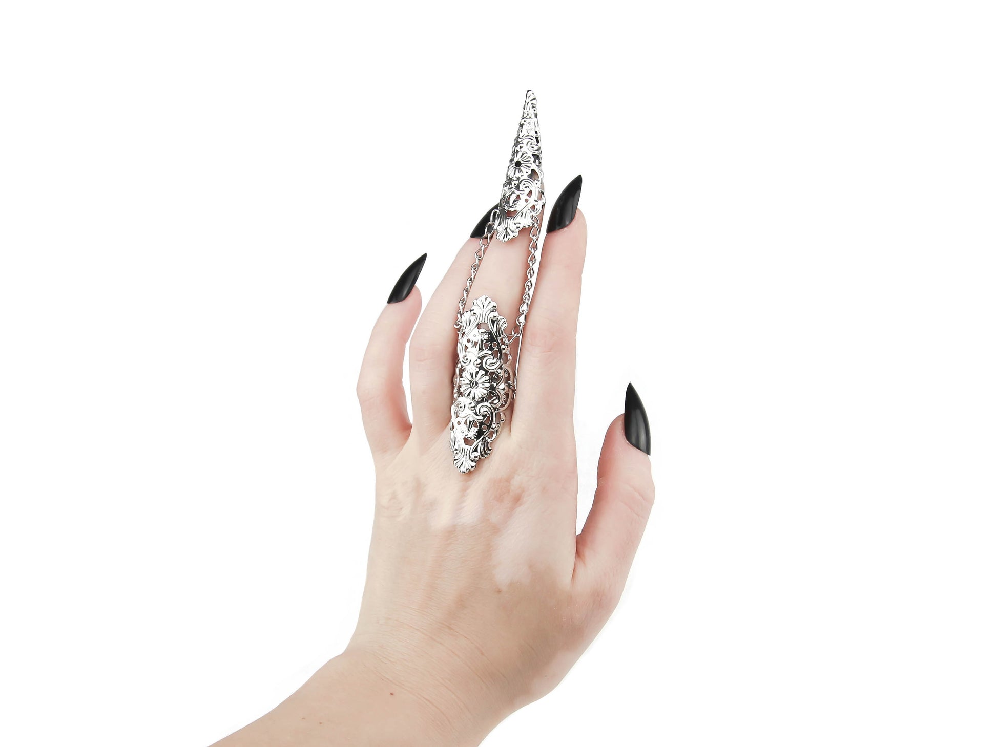 A hand models a Myril Jewels silver claw ring, its intricate black filigree embracing the wearer’s middle finger with gothic grace. This piece is a testament to the neo-goth aesthetic, a perfect addition to a Halloween ensemble or punk look. Designed for those who favor gothic-chic and whimsigoth trends, it's versatile enough for everyday wear, rave parties, or festivals, and makes a bold statement as a gift for a goth girlfriend.