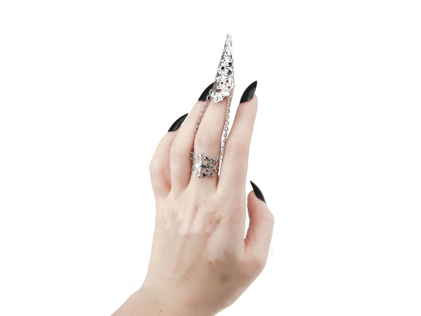 A hand adorned with Myril Jewels' intricate silver claw ring extends in a dramatic gesture, its dark avant-garde design complementing the bold black nail polish. Perfect for those with a love for Neo Gothic, Witchcore, and Gothic-chic styles, this ring is a statement piece for everyday wear and special occasions, including Halloween. Its craftsmanship and style cater to the unique tastes of punk and gothic lolita fashion enthusiasts