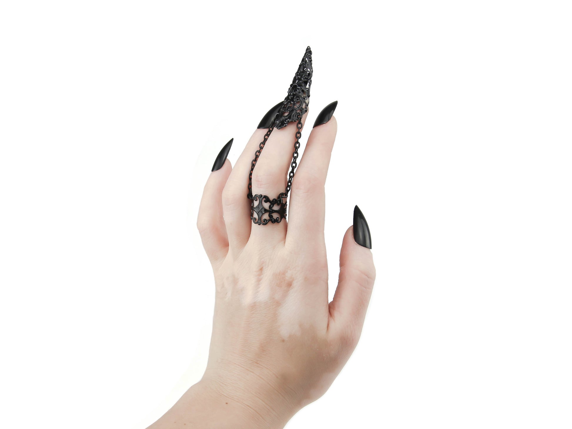 A bold, handcrafted Myril Jewels black claw ring adorns a slender finger, highlighted against a pristine background. This dark-avantgarde piece, with its intricate filigree design, is perfect for those who favor gothic, Witchcore, or Neo Gothic styles. It's an ideal accessory for Halloween, adding a touch of gothic-chic to everyday wear, and a staple for any Punk or Whimsigoth-inspired jewelry collection