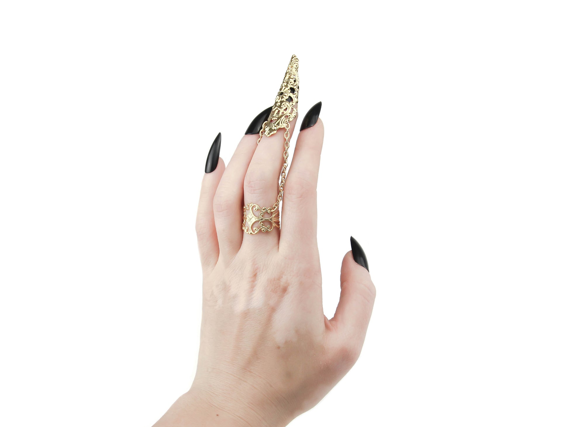 A hand adorned with Myril Jewels' exquisite gold armor ring with claw, featuring an elongated, ornate design connected by a delicate chain, is a statement of dark-avantgarde style. This piece captures the spirit of Neo Gothic and Gothic-chic, ideal for those with a love for gothic, Witchcore, and Whimsigoth aesthetics. It's a versatile accessory that enhances both Halloween ensembles and everyday wear