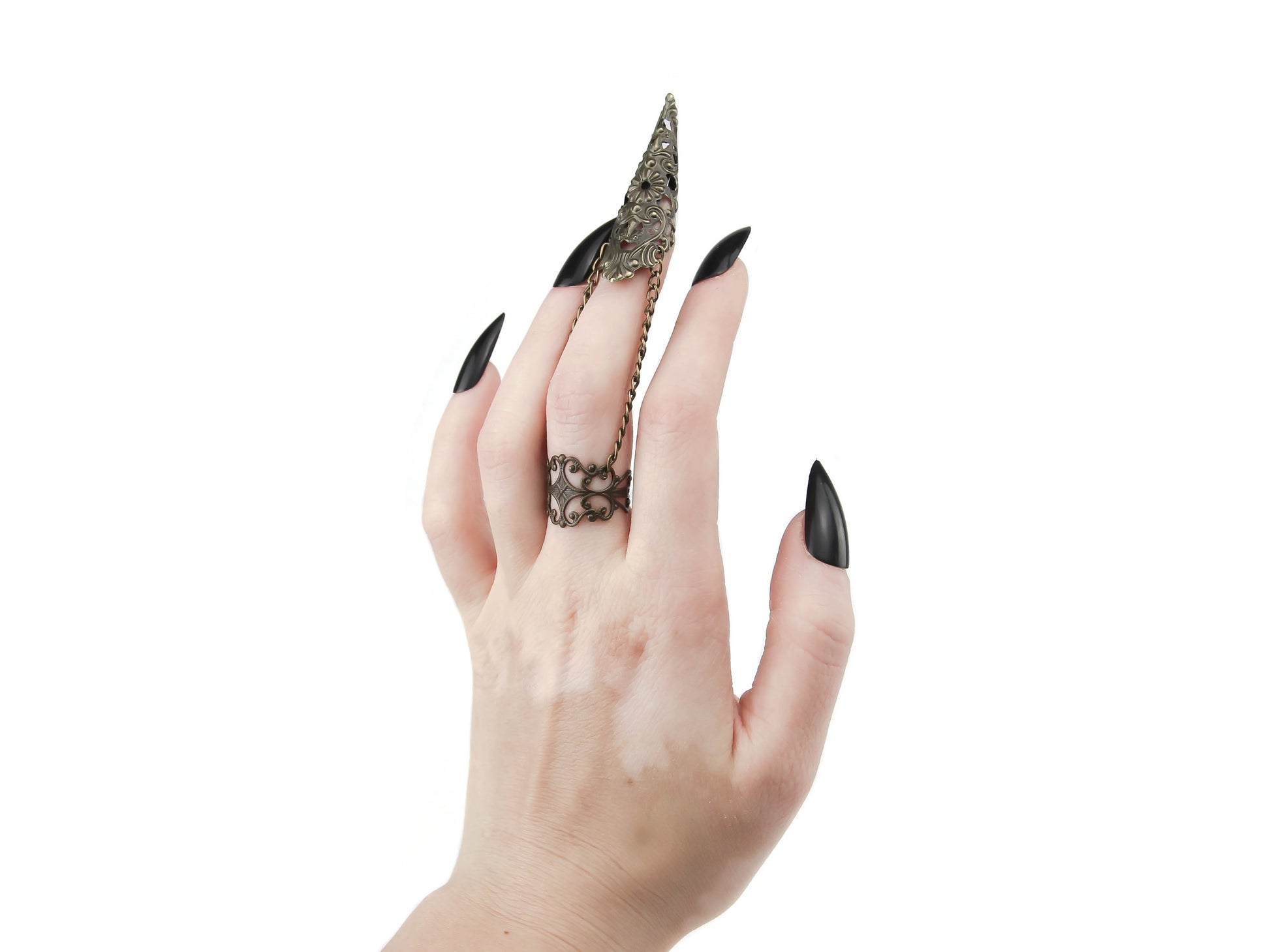 A bold and striking Myril Jewels bronze armor ring with claw, designed with a dark-avantgarde aesthetic, adorns a hand with sleek black nails, perfect for those with a love for gothic, Witchcore, and Neo Gothic styles. This finely crafted piece is a testament to gothic-chic sophistication, making it a versatile choice for Halloween, everyday wear, or as a statement accessory for the alternative fashion lover.