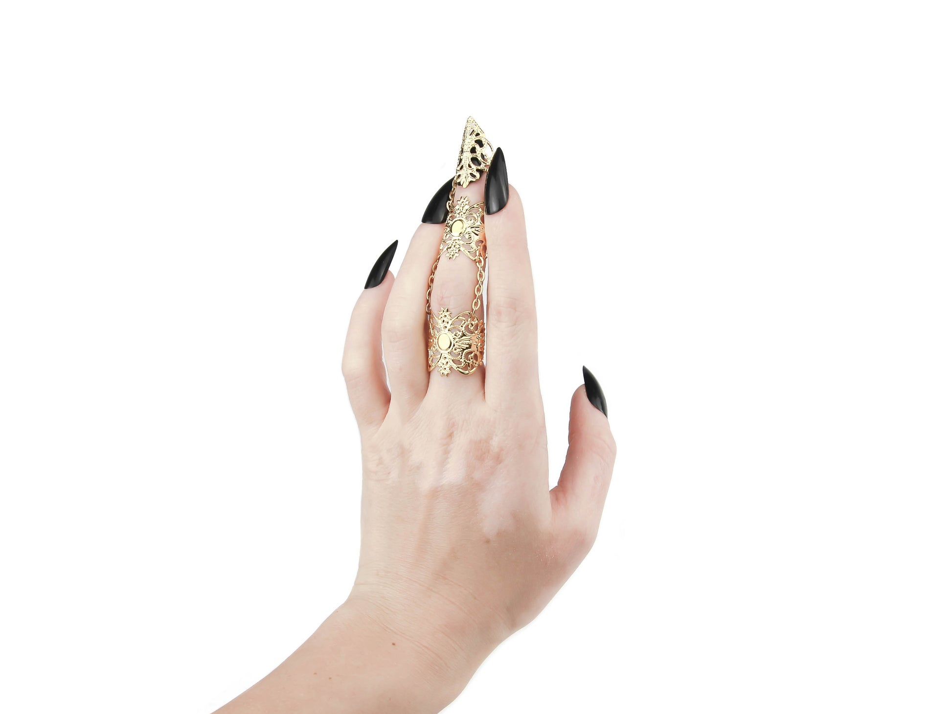 A hand flaunts a striking Myril Jewels gold full finger claw ring, boasting intricate neo-gothic details. Perfect for adding an edgy touch to gothic-chic styles or as a standout accessory for Halloween, this bold jewelry piece is a quintessential addition for anyone embracing a dark avant-garde or witchcore aesthetic