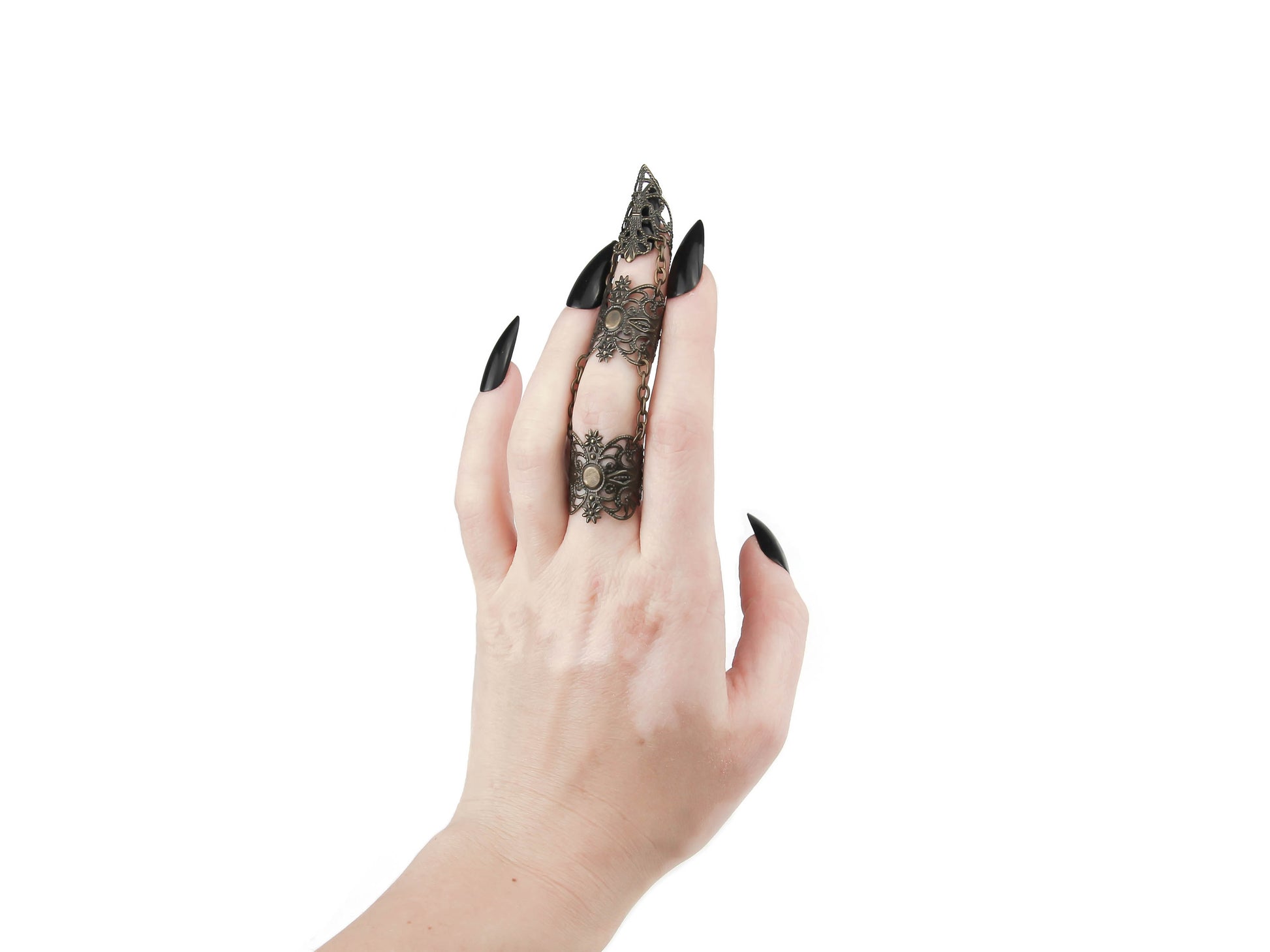A hand models an intricate bronze full finger claw ring by Myril Jewels, featuring a dramatic black filigree design that complements the neo-goth aesthetic. This bold piece is perfect for those seeking gothic-chic Halloween jewelry or a unique, statement accessory for minimal goth or witchcore fashion