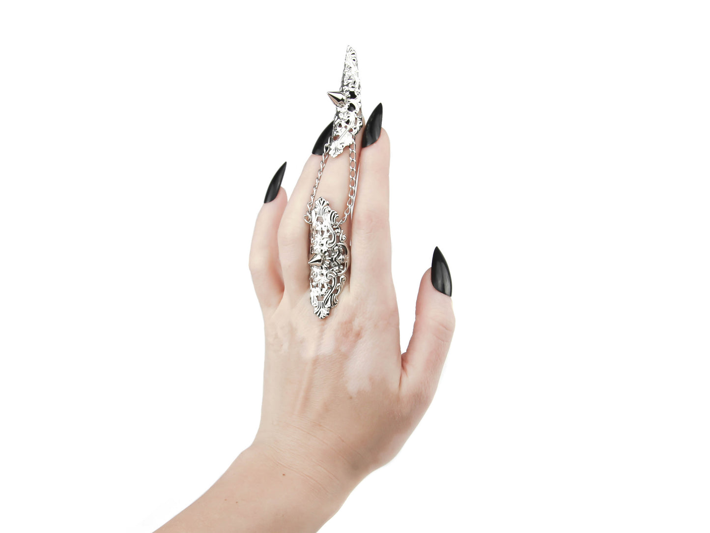 Captured is a Myril Jewels studded claw ring, a bold and intricate accessory that embodies neo-gothic design. Adorning the middle finger, its detailed craftsmanship highlights a dark, avant-garde aesthetic, making it a perfect match for gothic and alternative fashion enthusiasts. Ideal for enhancing Halloween outfits, adding edge to everyday wear, or as a statement piece at a rave or festival, this ring is a hallmark of Myril's unique, handcrafted jewelry collection.