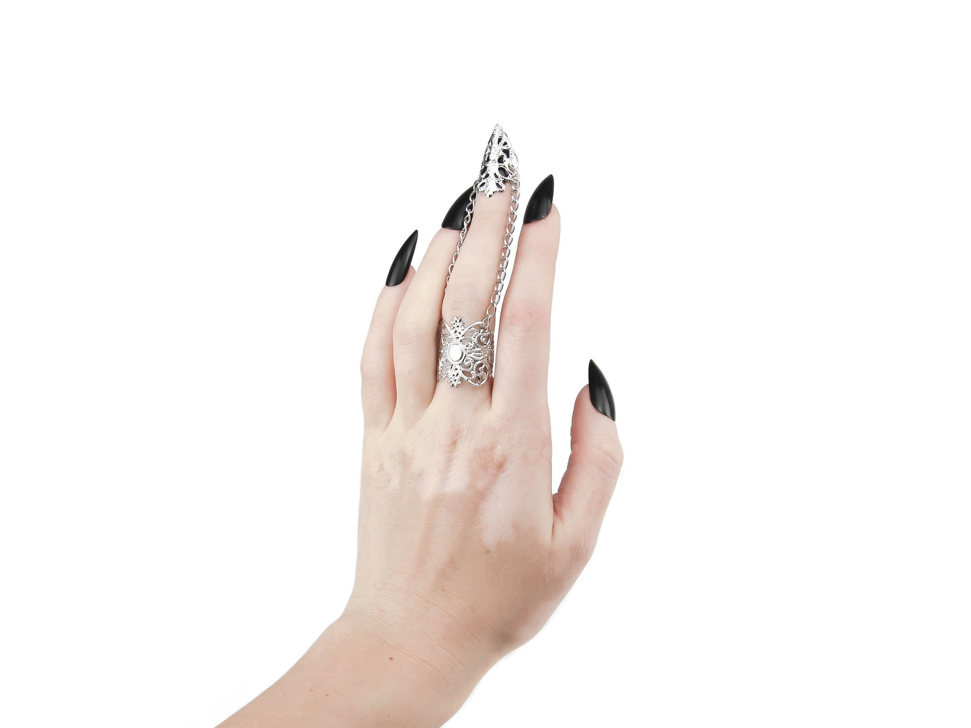 A hand models a Myril Jewels silver claw ring, its intricate black filigree embracing the wearer’s middle finger with gothic grace. This piece is a testament to the neo-goth aesthetic, a perfect addition to a Halloween ensemble or punk look. Designed for those who favor gothic-chic and whimsigoth trends, it's versatile enough for everyday wear, rave parties, or festivals, and makes a bold statement as a gift for a goth girlfriend.