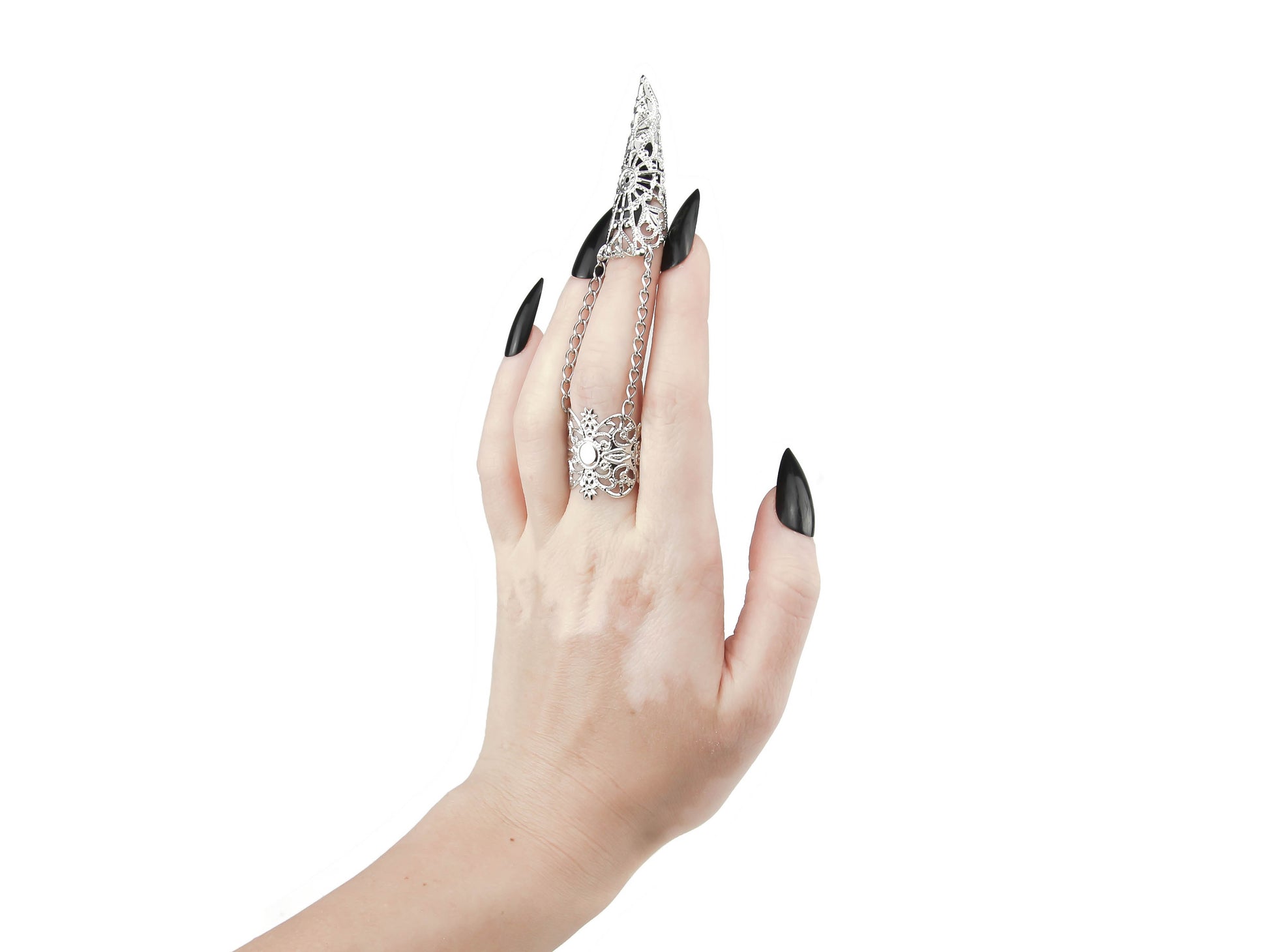 A hand models a Myril Jewels silver claw ring, its intricate black filigree embracing the wearer’s middle finger with gothic grace. This piece is a testament to the neo-goth aesthetic, a perfect addition to a Halloween ensemble or punk look. Designed for those who favor gothic-chic and whimsigoth trends, it's versatile enough for everyday wear, rave parties, or festivals, and makes a bold statement as a gift for a goth girlfriend.
