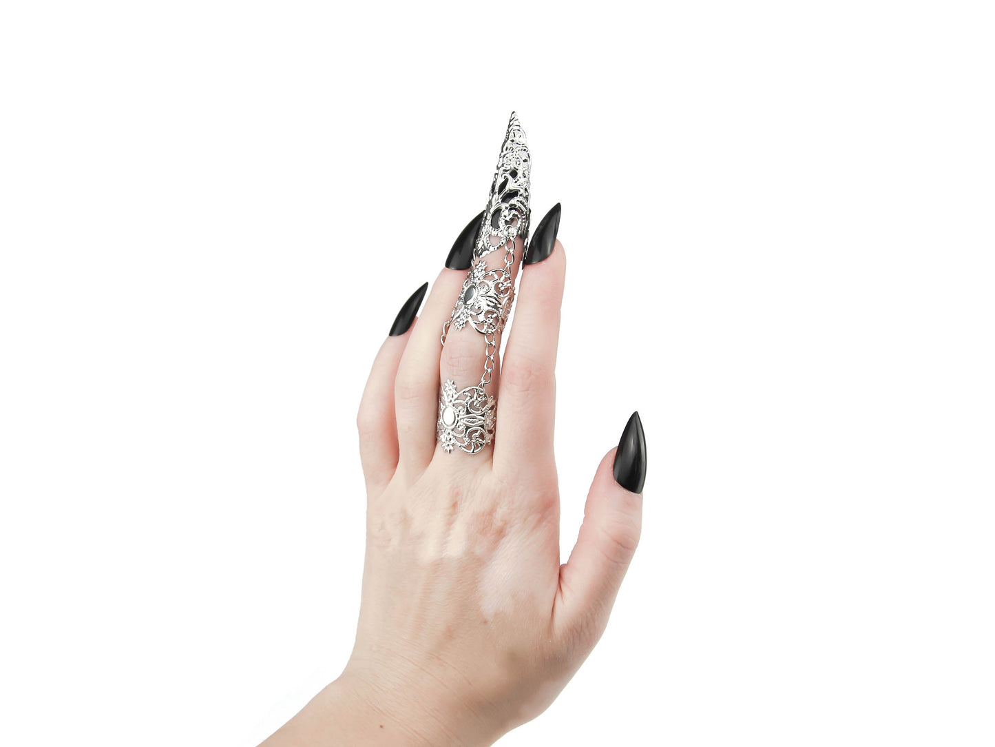 Showcased is a Myril Jewels full finger double ring, culminating in a long, ornate claw over the nail, exemplifying neo-goth jewelry design. The silver hue of the piece contrasts with the wearer's dark nail polish, highlighting the brand's dark-avantgarde aesthetic. This claw ring is ideal for those drawn to gothic-chic and witchcore styles, making it a perfect accessory for Halloween, everyday wear, or as an eye-catching addition to rave party and festival outfits.