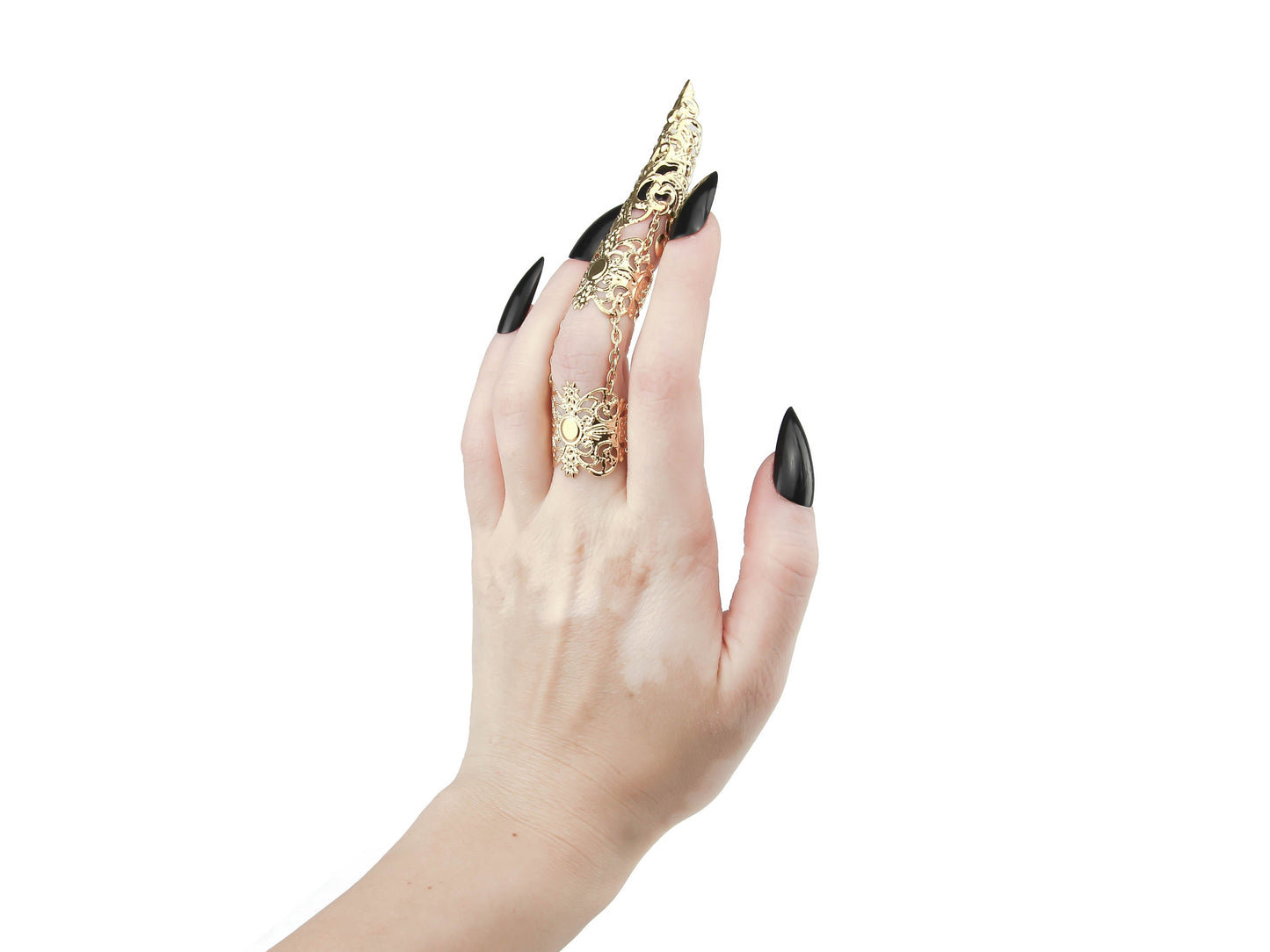 A hand models a Myril Jewels full finger gold double ring, featuring an ornate, long claw design that extends over the nail, exemplifying a bold neo-goth aesthetic. The claw ring's intricate details and golden sheen make it a perfect statement piece for gothic and alternative style enthusiasts. It’s a unique addition to any Halloween, punk, or gothic-chic jewelry collection, and suitable for witchcore, everyday wear, or as a striking accessory for rave parties and festivals.